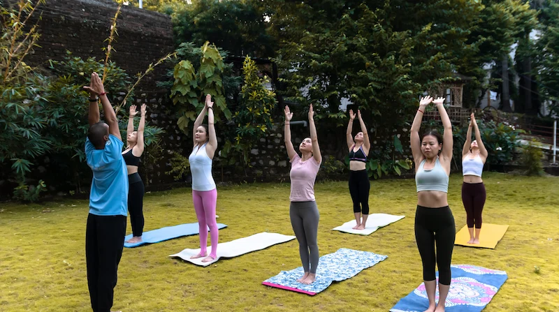 Yoga retreat group session on the banks of the Ganges in Rishikesh